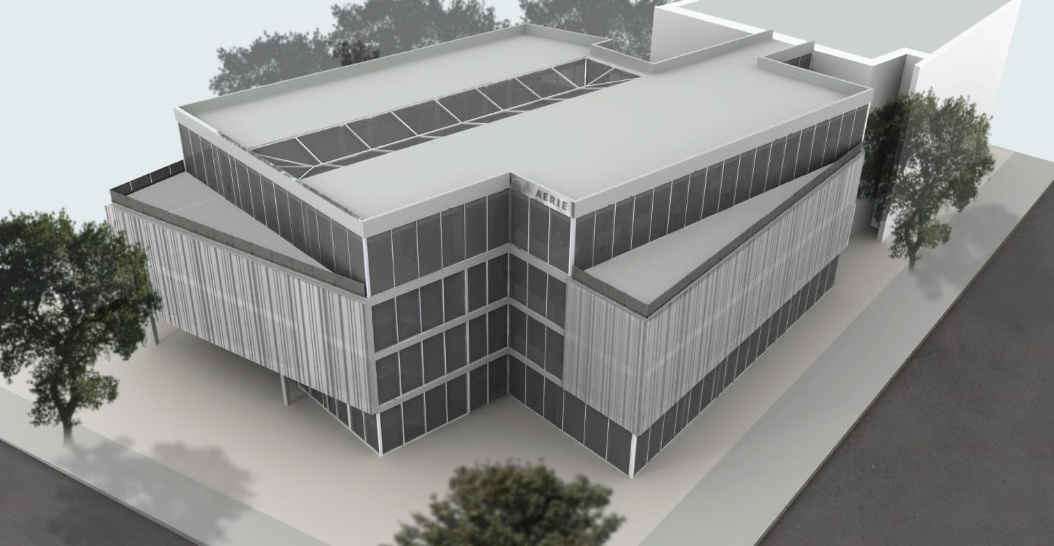 Aerial render of the Aerie building showing its L-shaped glass massing and the glazed atrium skylight in the roof