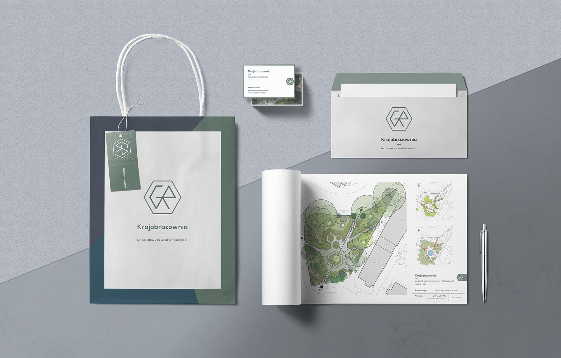 Krajobrazownia stationery flat-lay: branded shopping bag with hang tag, business card, envelope and a rolled landscape site plan