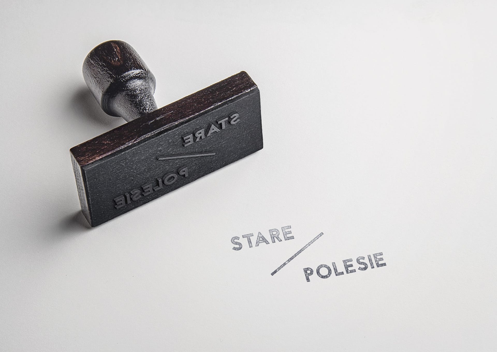 Wooden rubber stamp next to its inked Stare / Polesie logotype imprint